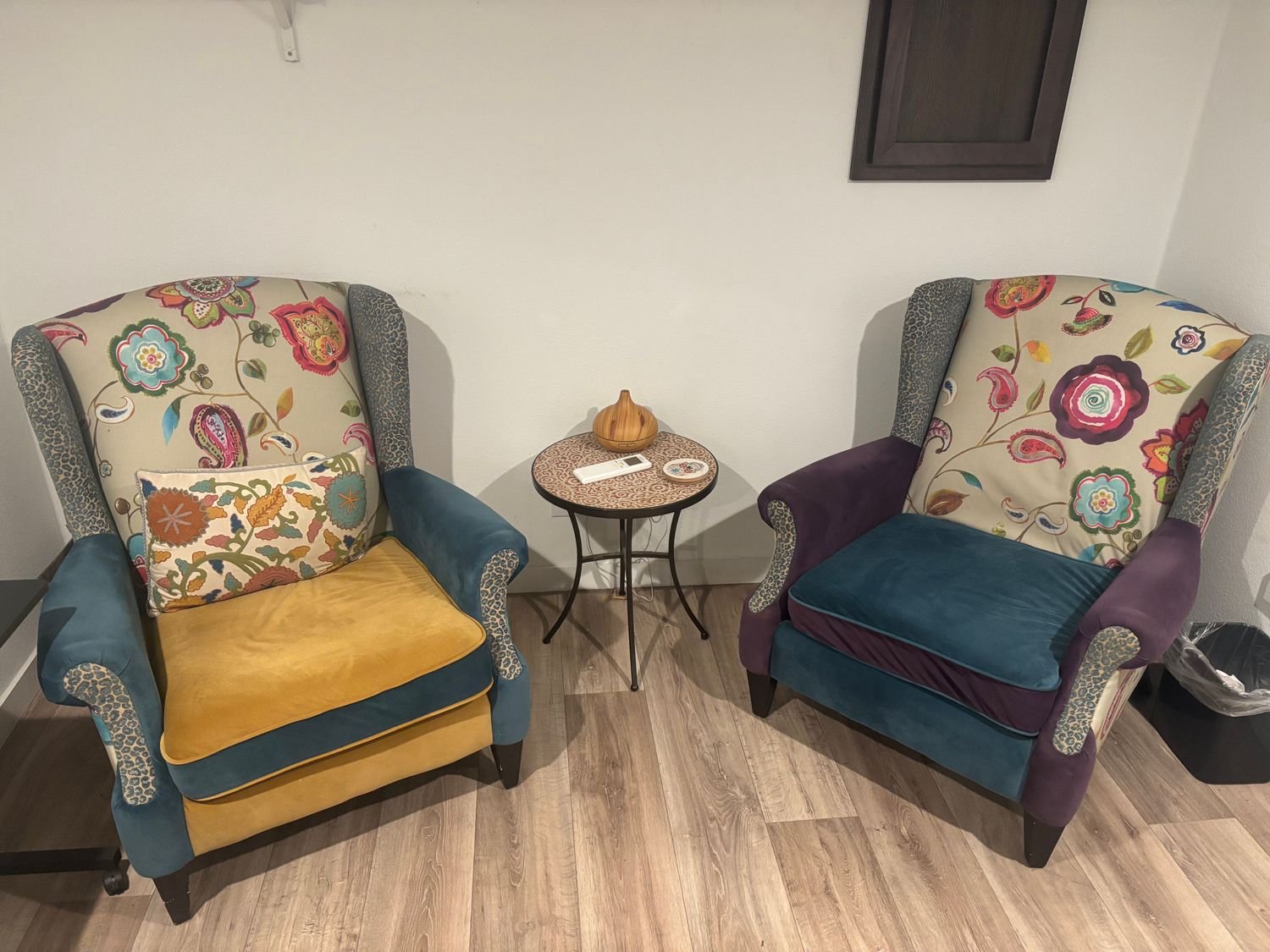 Therapy office with sage green walls and comfortable couch